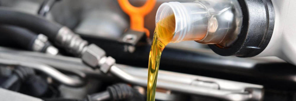 Fresh engine oil being poured into an engine